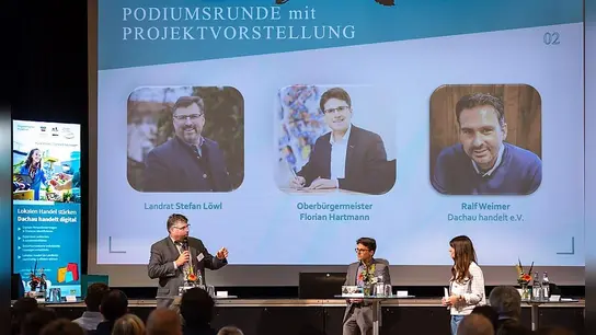Landrat Stefan Löwl (li) und Oberbürgermeister Florian Hartmann mit Moderatorin Marisa Schneider auf dem Podium. (Foto: Dachau handelt e.V.)