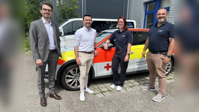 Denise Stalph (Mitte) mit dem BRK-Kreisgeschäftsführer Dennis Behrendt (links), Jan-Philipp Madignier und Martin Noß (rechts). (Foto: BRK Dachau)