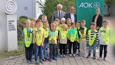 Gemeinsam für mehr Sichtbarkeit: Erdweger Erstklässler und (von li) Adrian Wiedenmann, Kreisverkehrswacht, Maximilian Georg, Direktor AOK und Barbara Matzgeller, komm. Schulleiterin. (Foto: AOK)